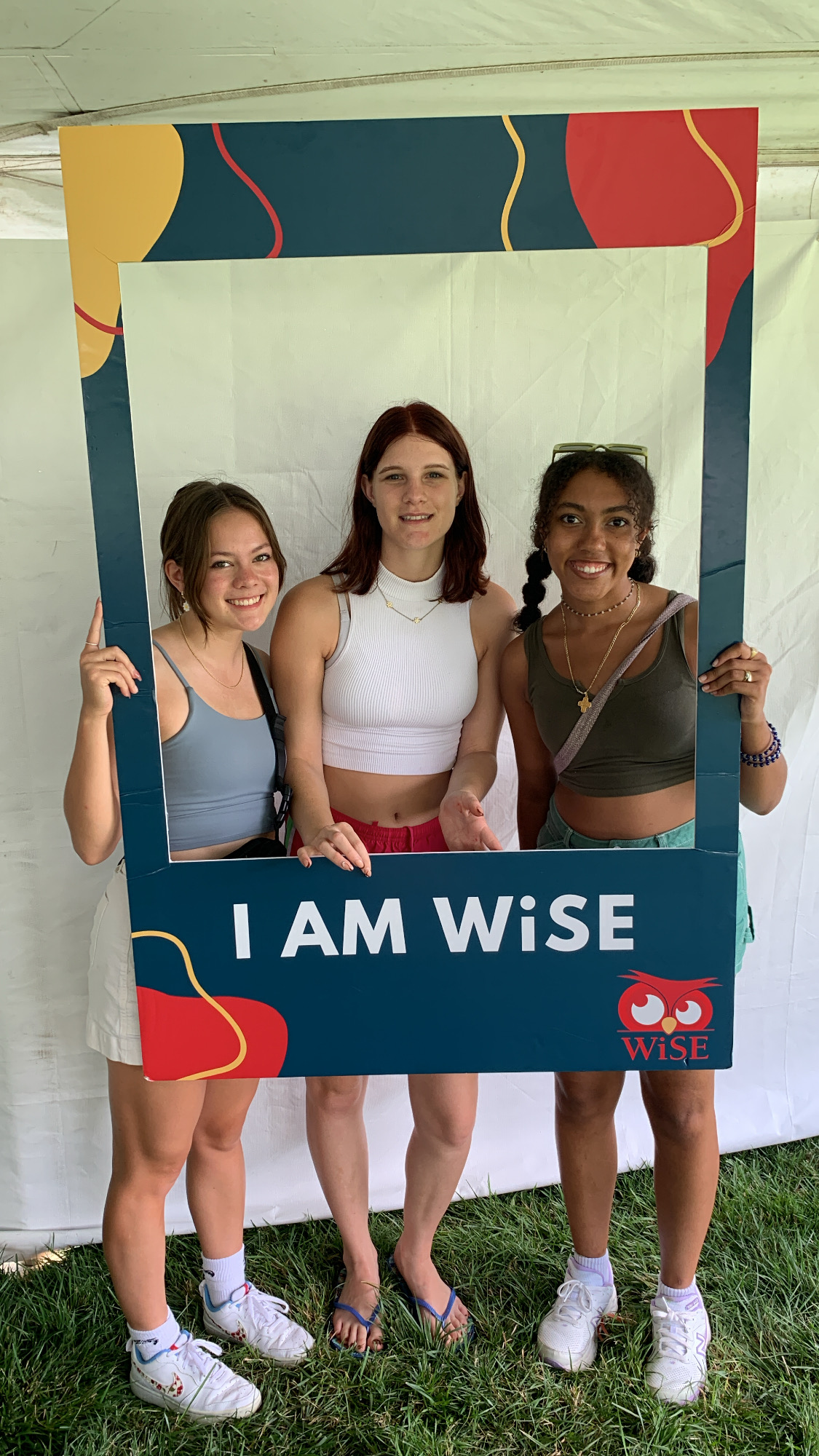Three students posing with the I Am WiSE sign