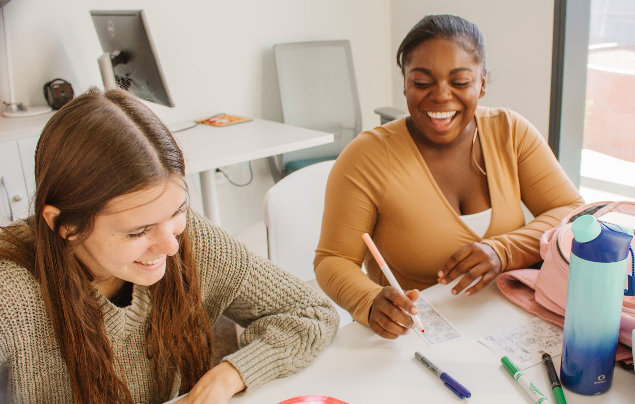 Two students smiling and studying