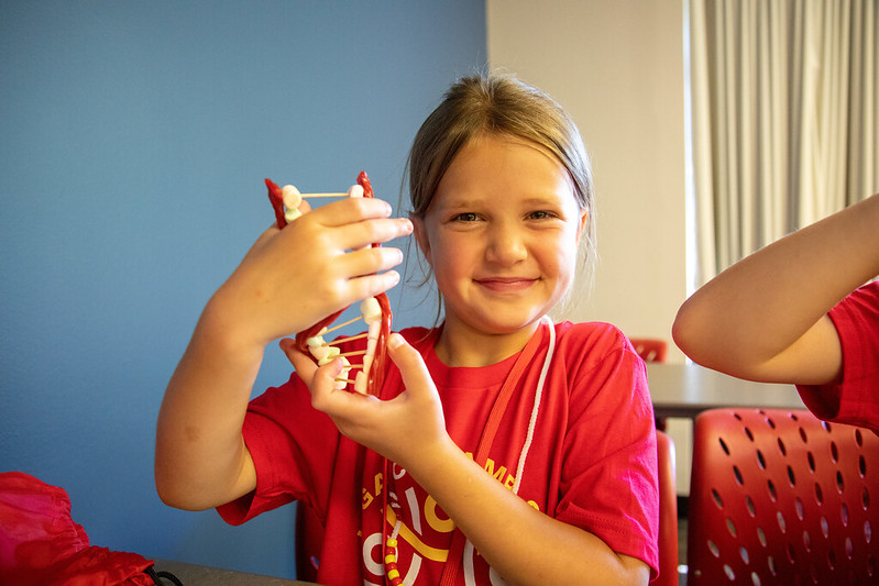 STEM Explorations student holding up a DNA model 