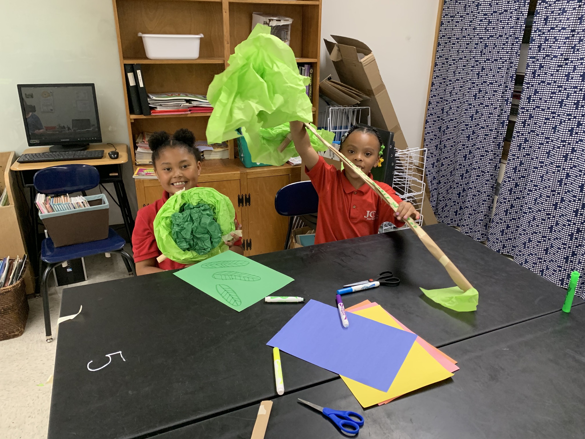 Two students posing with their trees during and SRM visit