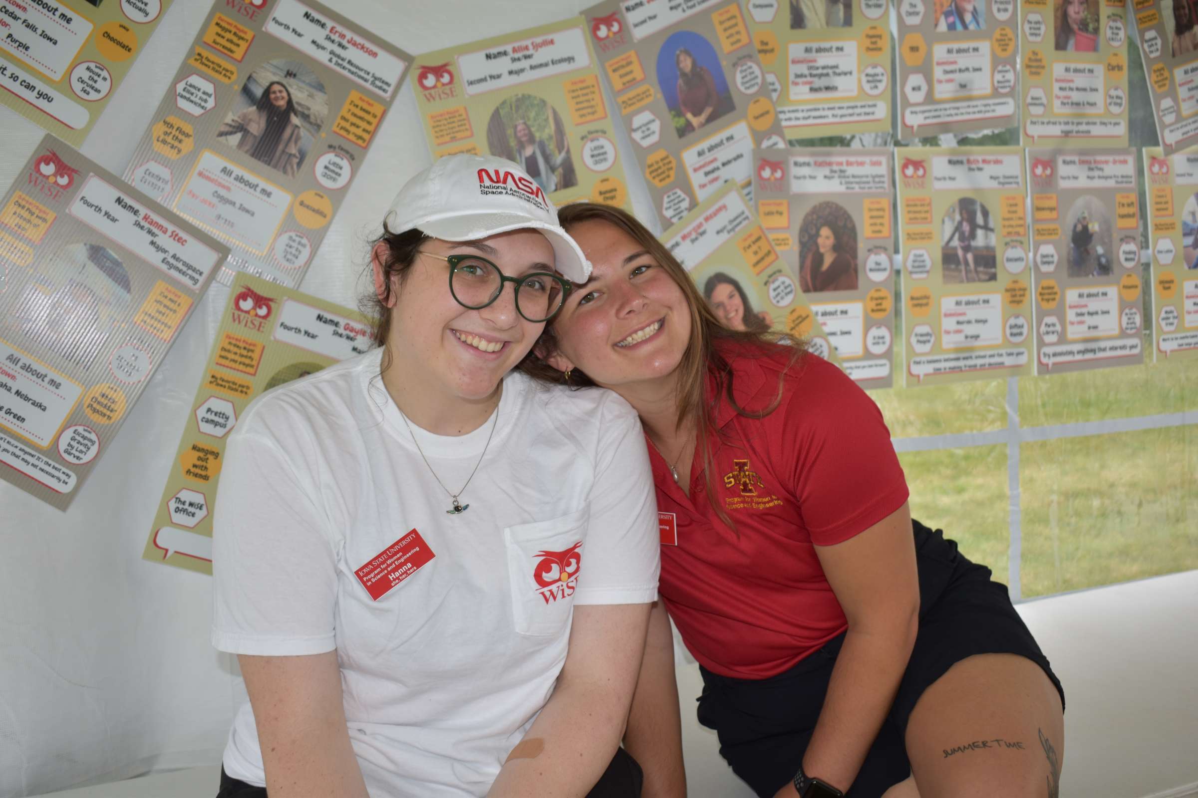 Two students smiling in the Community Groups tent at the WiSE Welcome